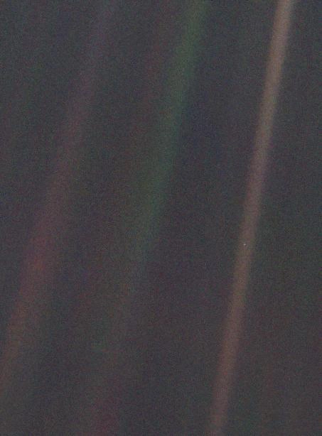 The Pale Blue Dot: A historic photograph taken by NASA's Voyager 1 spacecraft in 1990 from 3.7 billion miles away, showing Earth as a nearly imperceptible, pale blue dot surrounded by scattered rays of sunlight.